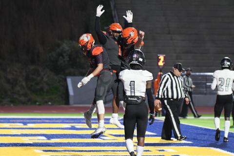 Habersham Central’s Caleb Wade (left) and Carson Parker (right) congratulate teammate Sirmarcus Burney on one of his three touchdowns. TOM ASKEW/Special