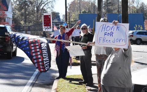 Protestors on the campus of Piedmont University ask drivers on Historic Highway 441 to honk in support of their opposition to vaccine mandates Wednesday afternoon. MATTHEW OSBORNE/Staff