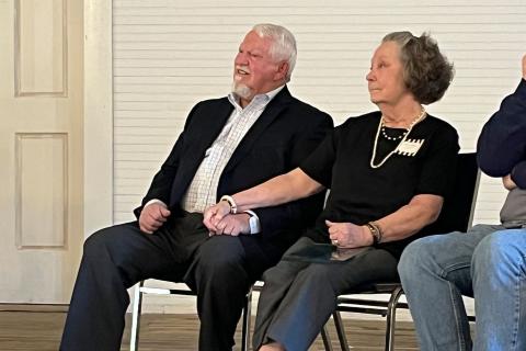 Mt. Airy Mayor Gary Morris listens to folks say nice things about him Friday at the Mt. Airy Schoolhouse building along with his wife Joan. MATTHEW OSBORNE/Staff