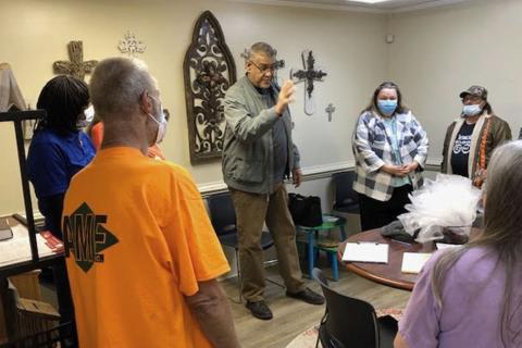 Pastor Sam Negron prays with clients at Grace Gate Clinic. CAROL JOHNSON/Submitted 
