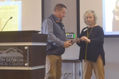 Todd Harper receives the Habersham County Friend of Agriculture award at Friday’s breakfast event from Barbara Rhodes, Habersham Chamber ambassador. BRIAN WELLMEIER/Staff