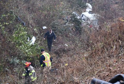 Habersham County first responders assess the wreckage of a car that veered off Old Cleveland Road. MATTHEW OSBORNE/Staff
