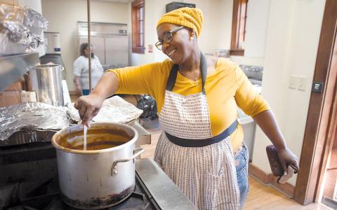 Cynseria Jenkins serves up food at the Thanksgiving meal Thursday at Cornelia Community House. TOM ASKEW/Special