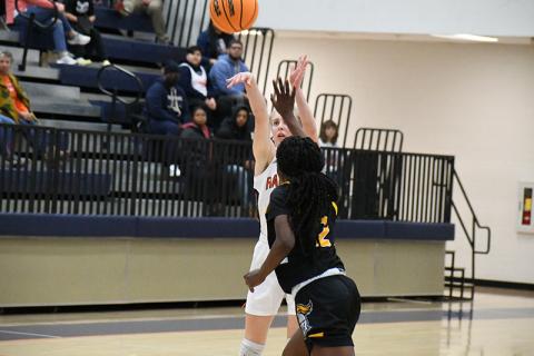 Habersham Central's Kelsey Banks puts up a 3-pointer with a Central Gwinnett defender right on her Friday night. MATTHEW OSBORNE/Staff