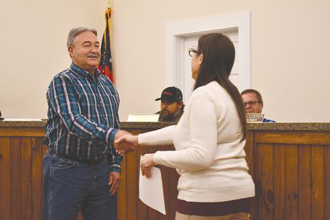 Mt. Airy Mayor Ray McAllister shakes hands with clerk Sheri Berrong after being sworn in Monday night. 