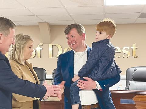 Demorest Mayor Jerry Harkness celebrates his official swearing-in Monday night with son Hunter, wife Meredith and father Bruce Harkness, who is a Habersham County Commissioner.