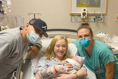 Daelynn Gordon (middle) holds her baby girl Mia with father Alex Ramirez and midwife Emily Jones at Habersham Medical Center on Jan. 1. MATTHEW MILES/Submitted