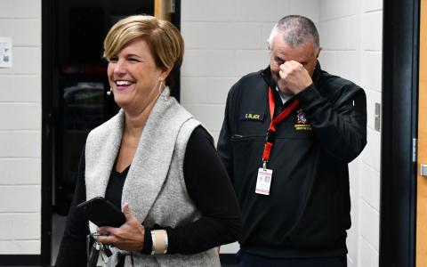 Retiring Emergency Services Director Chad Black got a surprise party on his way out Friday, attended by many county staff, officials and fellow first responders. He is shown above as he walks into the trap with County Manager Alicia Vaughn at the Ruby Fulbright Aquatic Center. MATTHEW OSBORNE/Staff