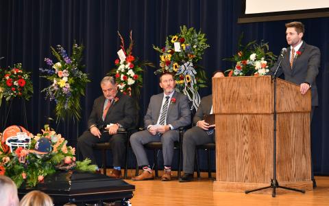 Sawyer  Dover  eulogizes  his father Shane at  Saturday’s memorial service at Habersham Central High School as the Rev. Doug Porter,  Coach Benji Harrison and Dr. Brian James  (obscured) listen in. MATTHEW OSBORNE/Staff