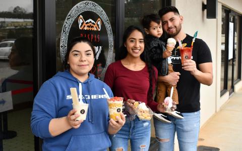 Nancy Covarrubias, Yesenia Covarrubias, little Aaron, and Luis Antonio Covarrubias show off some of the  delicious treats from Raspas El Tigre in Cornelia. AMARIS E. RODRIGUEZ/Staff 