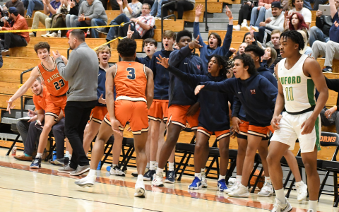 The Raiders bench went crazy after Malachi Dooley hit a three pointer in the second half of the region semifinal game against Buford. CODY ROGERS/Staff
