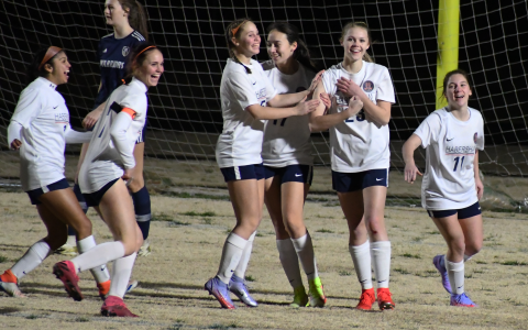 Habersham Central’s Sarah Clark flexes after a goal as she is mobbed by teammates (from left) J.R. Campbell, Sydney Turner, Piper Turner, Madison Gabrels and Ansley Means. CODY ROGERS/Staff