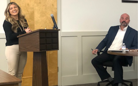 Karla Paramo smiles during her part of the presentation about parent involvement coordinators at the Feb. 10 work session as Superintendent Matthew Cooper listens. AMARIS E. RODRIGUEZ/Staff 
