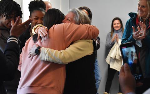 Tinisha Combs embraces Nanette Baughman after receiving keys to her new home Sunday. BRIAN WELLMEIER/Staff