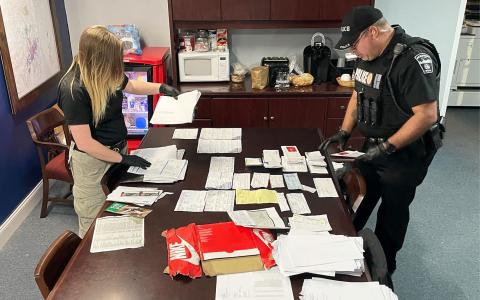 Habersham County Sheriff’s Crime Scene Technician Kayla Neal (left) and Demorest Officer James Minutello look over stolen mail seized after the arrest of Dylan Shope on Thursday. HABERSHAM COUNTY SHERIFF’S OFFICE/Submitted