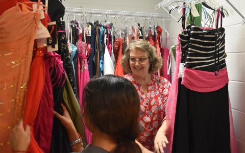 Donna Barrett helps students look through dresses at the Habersham Prom Dress Closet. AMARIS E. RODRIGUEZ/Staff