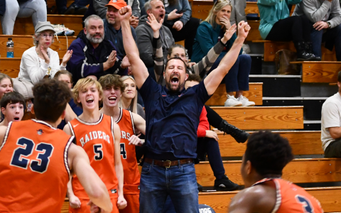 Coach Aric Mawdesley celebrates alongside the Raiders players on the bench after Cole Gary’s first dunk of his high school career. CODY ROGERS/Staff
