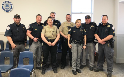 Habersham School Resources Officers (from left) Deputies Austin Martin, Wesley Littlejohn, Brittany Hallman, Paul Kent, Paul Harris, Evaleese Gonzalez, David Jackels and Sgt. Griggs Wall, along with Chief Deputy Murray Kogod (back), gather at Monday’s School Board meeting. AMARIS E. RODRIGUEZ/Staff