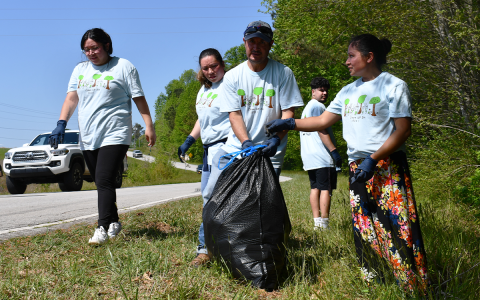 Baldwin residents collect trash from the roadside on Clean Up Day Saturday. BRIAN WELLMEIER/Staff