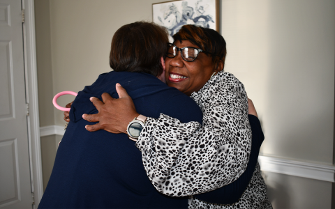 Circle of Hope volunteers Brandy Whitener and Gwendolyn Wiley embrace following a spark of recognition Wednesday. BRIAN WELLMEIER/Staff