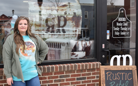 Owner Kayla Clackum flashes a smile as she awaits the grand opening of her first brick-and-mortar boutique, Rustic Rebel Boutique, in downtown Clarkesville on Saturday. AMARIS E. RODRIGUEZ/Staff
