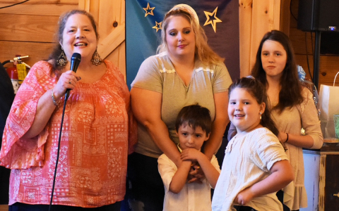 Tam Terrall, Family Services director, confers with a family from the Family Promise program. MARTIE BROOKS/Submitted