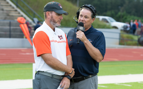 Chris Black (right) gets an interview with Raiders coach Benji Harrison before a big game. Black has been on WCON Radio for 31 years. TOM ASKEW/Special