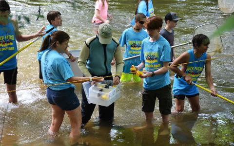 Scouts from Troop 5 fish rubber ducks out of the Soque River during last year’s race.