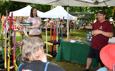 Local artist Kristin Davis (left) interacts with artists Ken Pease (right) and Charlie Dingle (center). BRIAN WELLMEIER/Staff