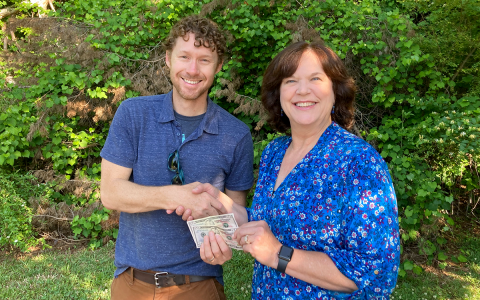 Dahlonega resident Rhonda Hardy receives her $100 prize money from The Dahlonega Nugget publisher Matt Aiken. Hardy’s photo of vintage Porsches traveling in the Northeast Georgia mountains will grace the cover of the 2022 summer edition of The Mountain Traveler magazine. CNI NEWS SERVICE