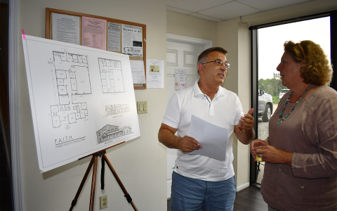 Board member and architect Bob DeFiore explains Power House design plan to FAITH volunteer Collin Lines. BRIAN WELLMEIER/Staff
