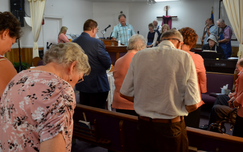 Pastor Joe Frady leads the congregation in prayer Sunday at Old Nacoochee Baptist Church. The church is on the border of Habersham and White counties and has been at its present home since 1851. WAYNE KNUCKLES/CNI News Service