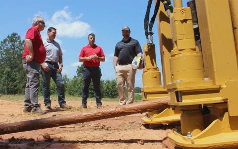 John Cantwell, Kinetic engineering and construction manager; Michael Foor, Kinetic Georgia state operations president; Blake Fields, Kinetic field operations director; and Georgia Sen. Bo Hatchett, District 50, talk while standing next to a Kinetic surface drill rig, used to create boreholes for utility poles. GERARD HARRINGTON/Submitted