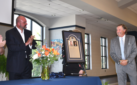 Superintendent Matthew Cooper (left) applauds Marlan Wilbanks on his lifetime achievement award at Habersham Central High School at a ceremony Friday. Wilbanks is the third such recipient since the award’s inception. BRIAN WELLMEIER/Staff