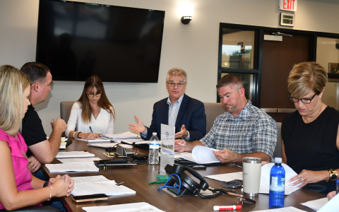 Brittany Taylor, associate attorney with Hunt and Taylor Law Group, Justin Schapansky, Amanda Rostin and Phil Eberly Lead Edge Design, Airport Manager Will Regan and County Manager Alicia Vaughn discuss airport affairs at a Monday meeting. BRIAN WELLMEIER/Staff