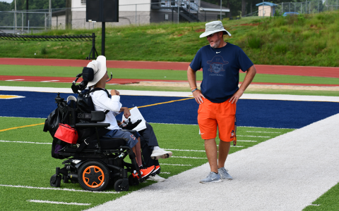 Habersham Central head coach Benji Harrison (right) consults with Coach Joseph York on how to get his young Raiders into shape for the Aug. 5 preseason scrimmage. MATTHEW OSBORNE/Staff