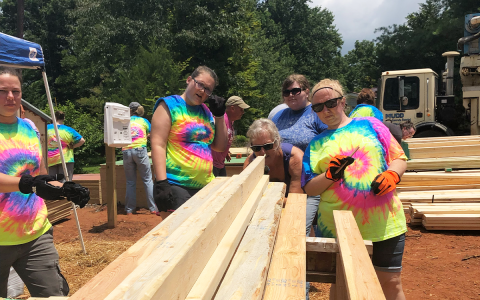 One of the teams from last year's Habitat Women Build inspect lumber before beginning work. NANETTE BAUGHMAN/Submitted