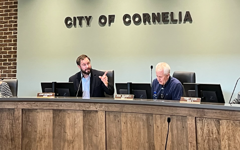Cornelia Mayor John Borrow consults City Manager Dee Anderson and City Attorney Steve Campbell across the room Tuesday. BRIAN WELLMEIER/Staff