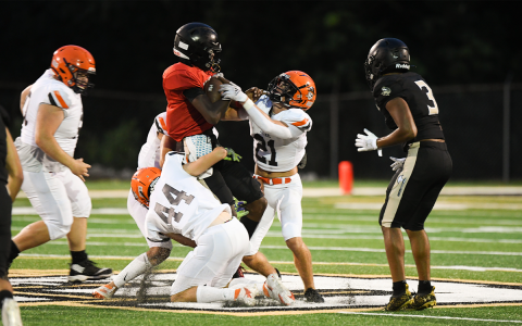 Habersham Central defenders Landyn Savage (21) and Caleb Blackburn (44) sack East Hall quarterback Jamarcus Harrison during the Raiders’ resounding 47-0 win in the preseason jamboree Friday night. TOM ASKEW/Special