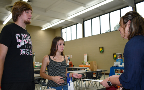 Young parents Connor Smith and Ariel Bennett inquire about resources at Mountain Education Charter School on Tuesday. BRIAN WELLMEIER/Staff