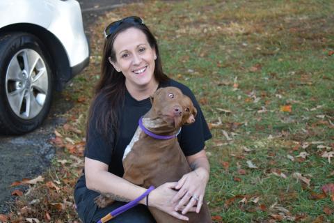 Olivia Whitfield, Administrative Assistant at Habersham County Animal Care and Control, cuddles Redman, a favorite of many at the rescue. JOHN DILLS/Staff