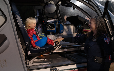 Briggs Schiflett, dressed as Spider-Man, gets a tour of the AirLife helicopter by Flight Paramedic Jennifer Davis at the E-911 halloween festival on Oct. 20. ZACH TAYLOR/Special