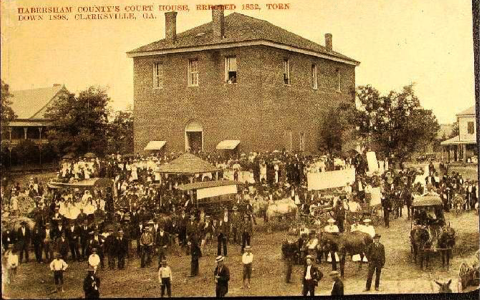 Shown is the second Habersham County Courthouse in the late 1800s. The building on the right is believe to be  the residence of Charles and Amanda Deas.