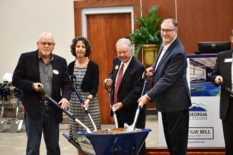 Mitchel Barrett, Eleanor Ivester, John Wilkinson and Cliff Bradshaw dig in to mark the start of the new building at NGTC on Thursday. JOHN DILLS/Staff