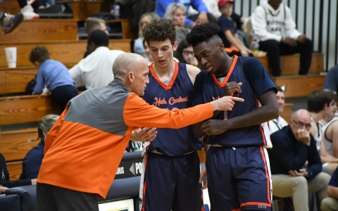 Raiders coach Tommy Yancey instructs Cole Gary and Bryce Pittman during the season opener. CODY ROGERS/Special
