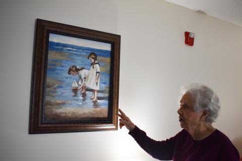 Magnolia Hills resident Mary Lou Martin admires a painting in her room, reminding her of her grandchildren. EMMA MARTI/Staff