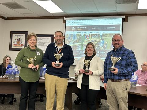 Principals (from left) Lana Jones, Jonathan Stribling, Georgia Pitts and Ernie Garrett receive their attendance trophies at Monday night’s Board of Education meeting. EMMA MARTI/Staff