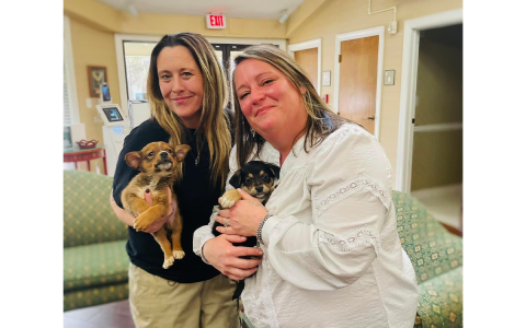 Madi Nix (left) and Baldwin Mayor Alice Venter (right) brought cards signed by puppies on Valentine’s Day to The Oaks at Scenic View Assisted Living. MADI NIX/Submitted