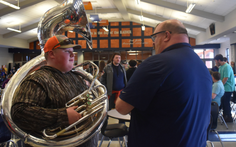 Ryan Dukes speaks with student Madison Benfield after a ceremony honoring him Wednesday at Habersham Central High School. EMMA MARTI/Staff