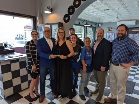 Accepting Fenders Alley’s travelblazer award on Wednesday are (from left) Jessie Owensby, Cornelia’s Community  Development Director; Fenders owners Jay and Melissa Reeder; employees Nelson Arias (in back), Mady Maysonet and  Kris Bernadino; Jay Markwalter, president of Georgia Convention and Visitors Bureau; and Cornelia Mayor John Borrow. STEFANIE BOWDEN/Staff